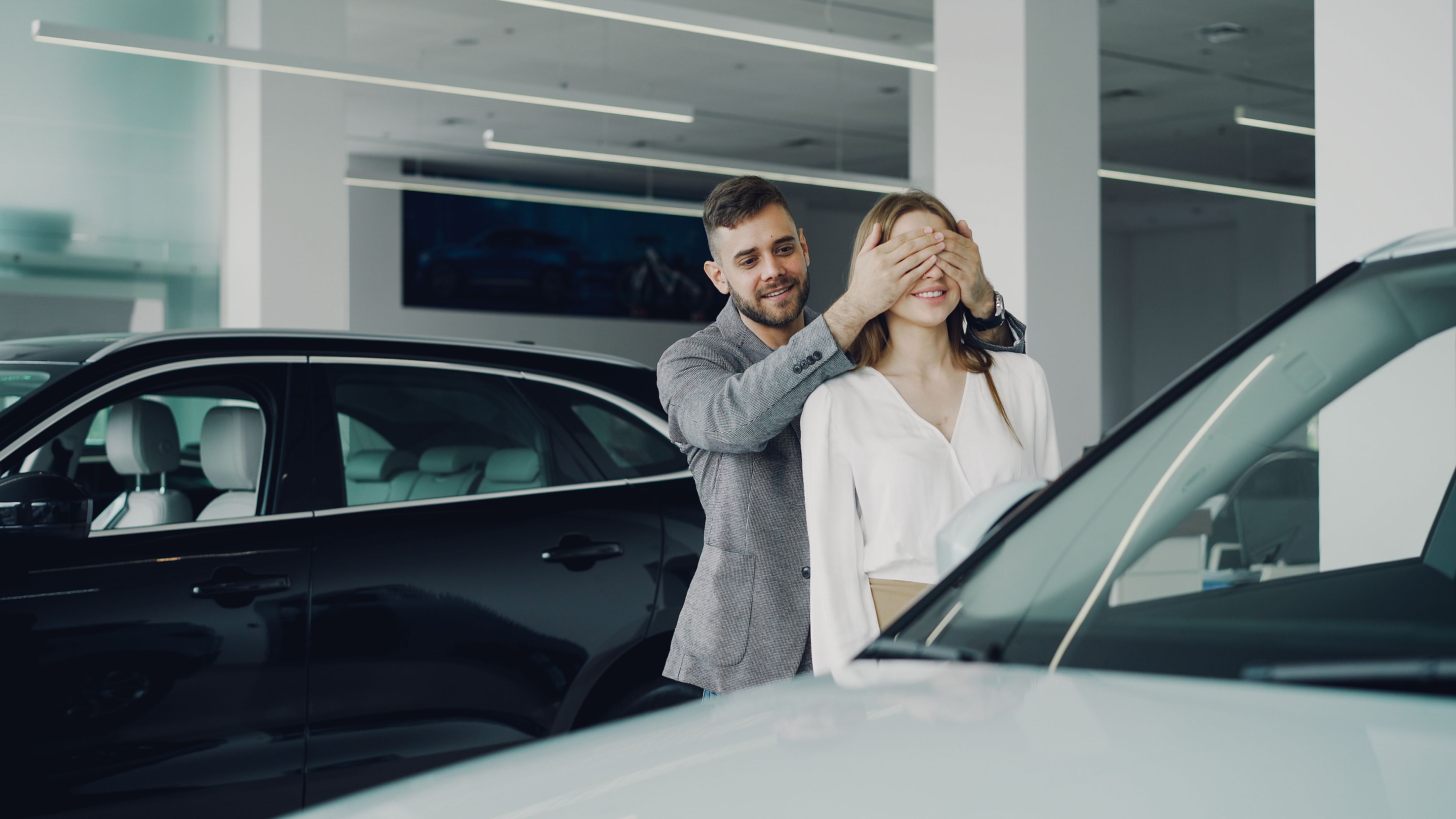 Happy customers picking up their new car